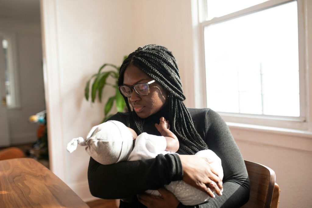 Black mum holding her new baby